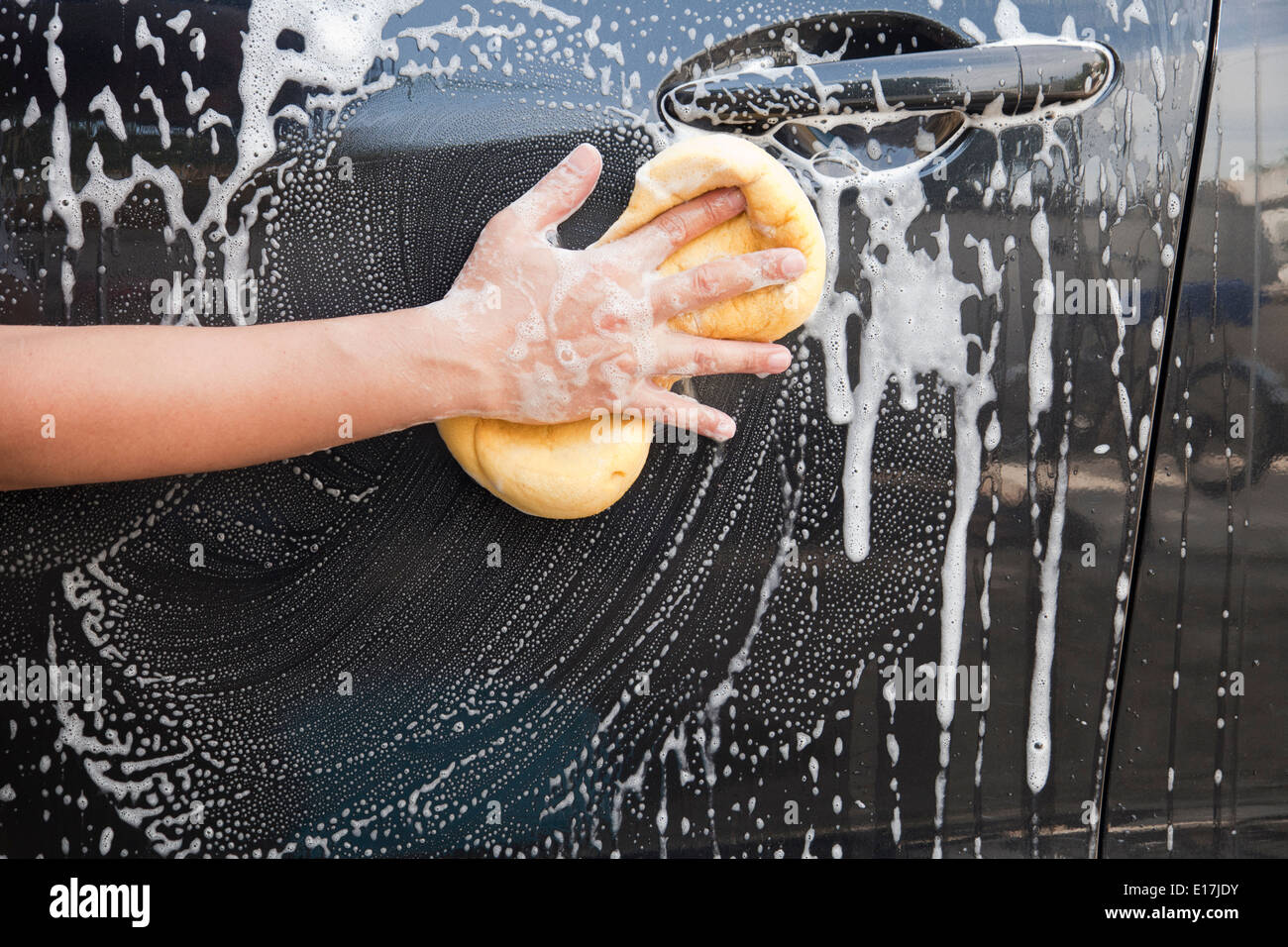 Washing a car with a sponge and soap Stock Photo Alamy
