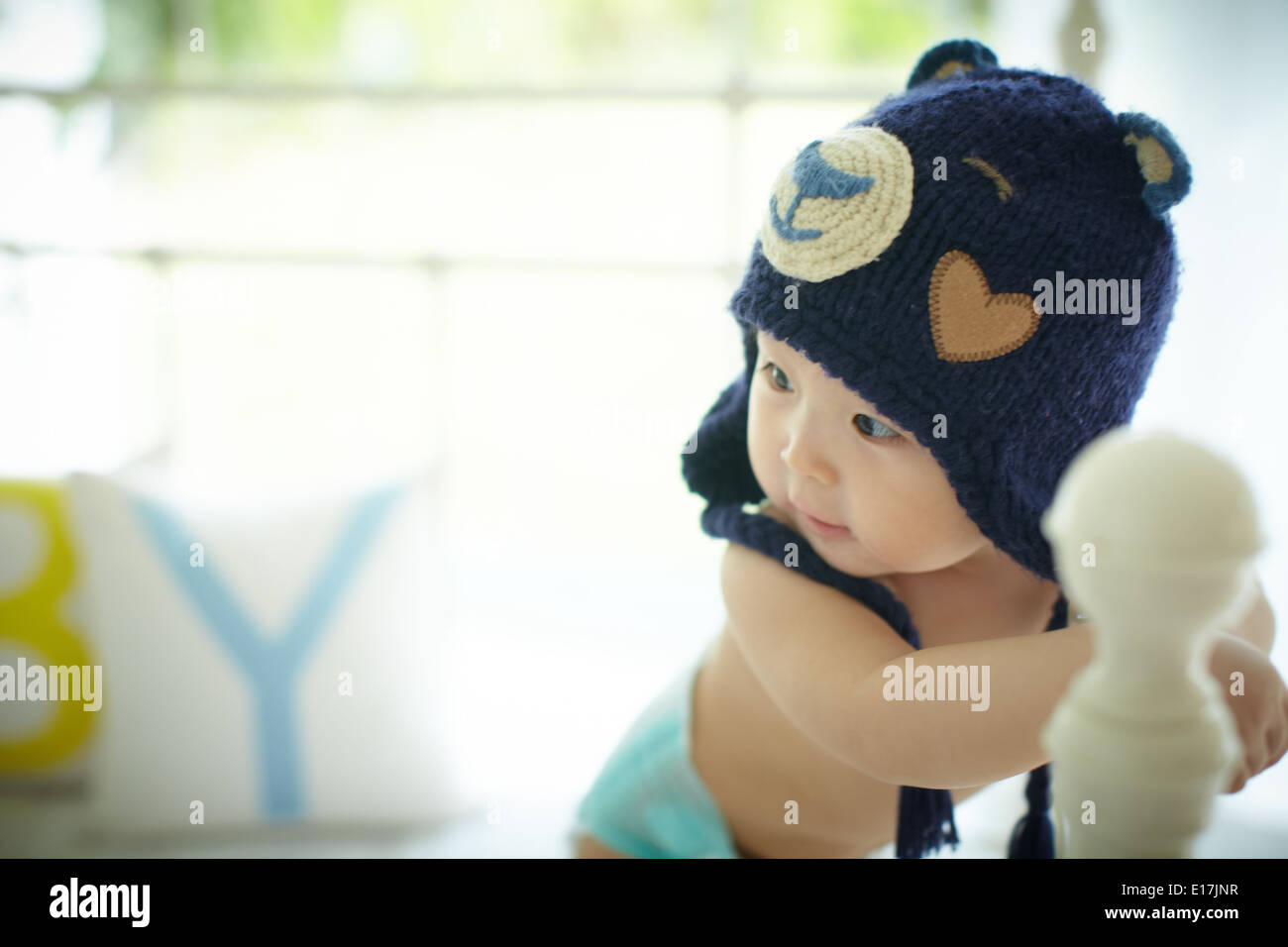Cute baby wearing a blue bear hat Stock Photo
