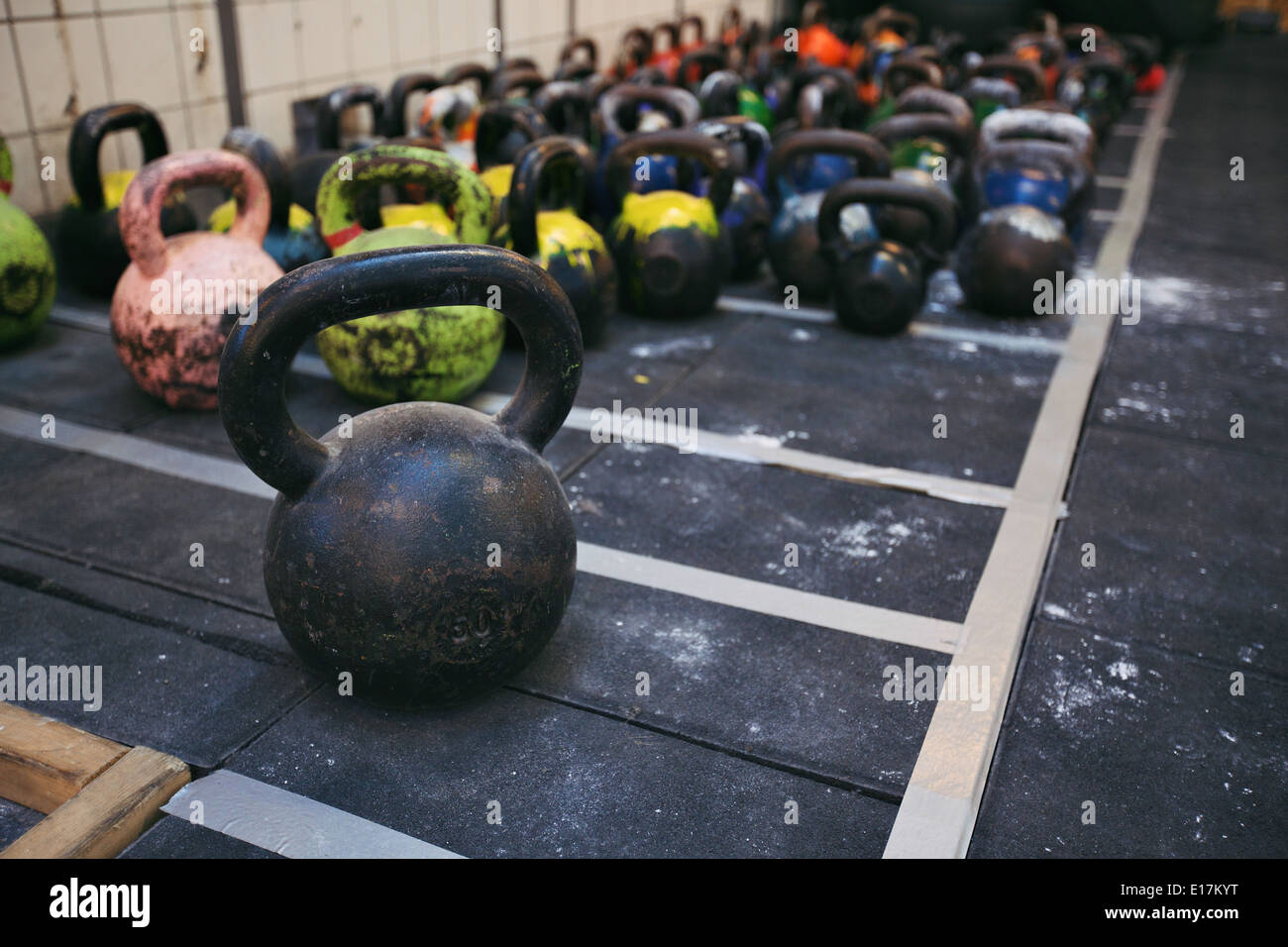 Different sizes of kettlebells weights lying on gym floor. Equipment