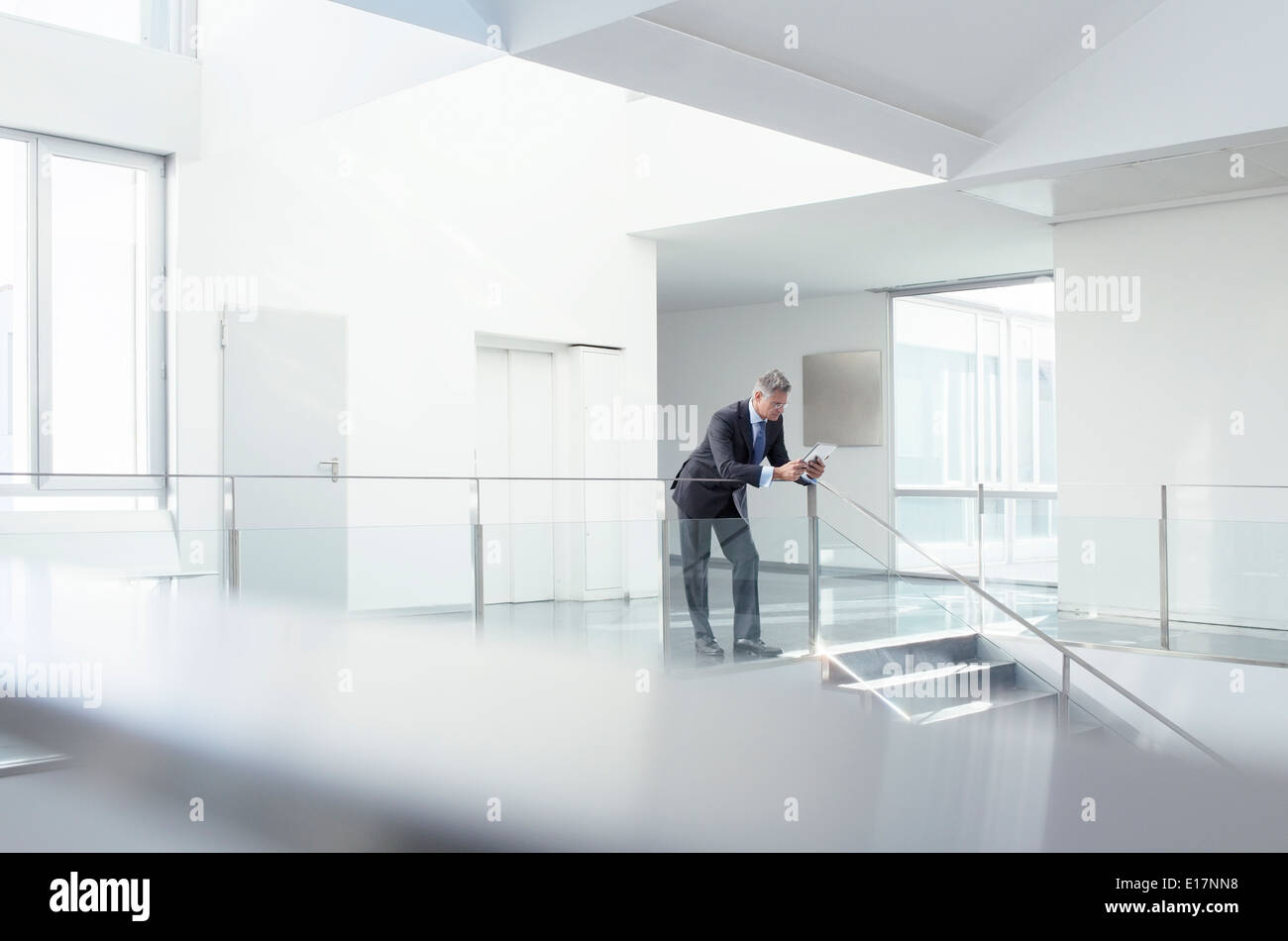 Businessman using digital tablet in corridor Stock Photo