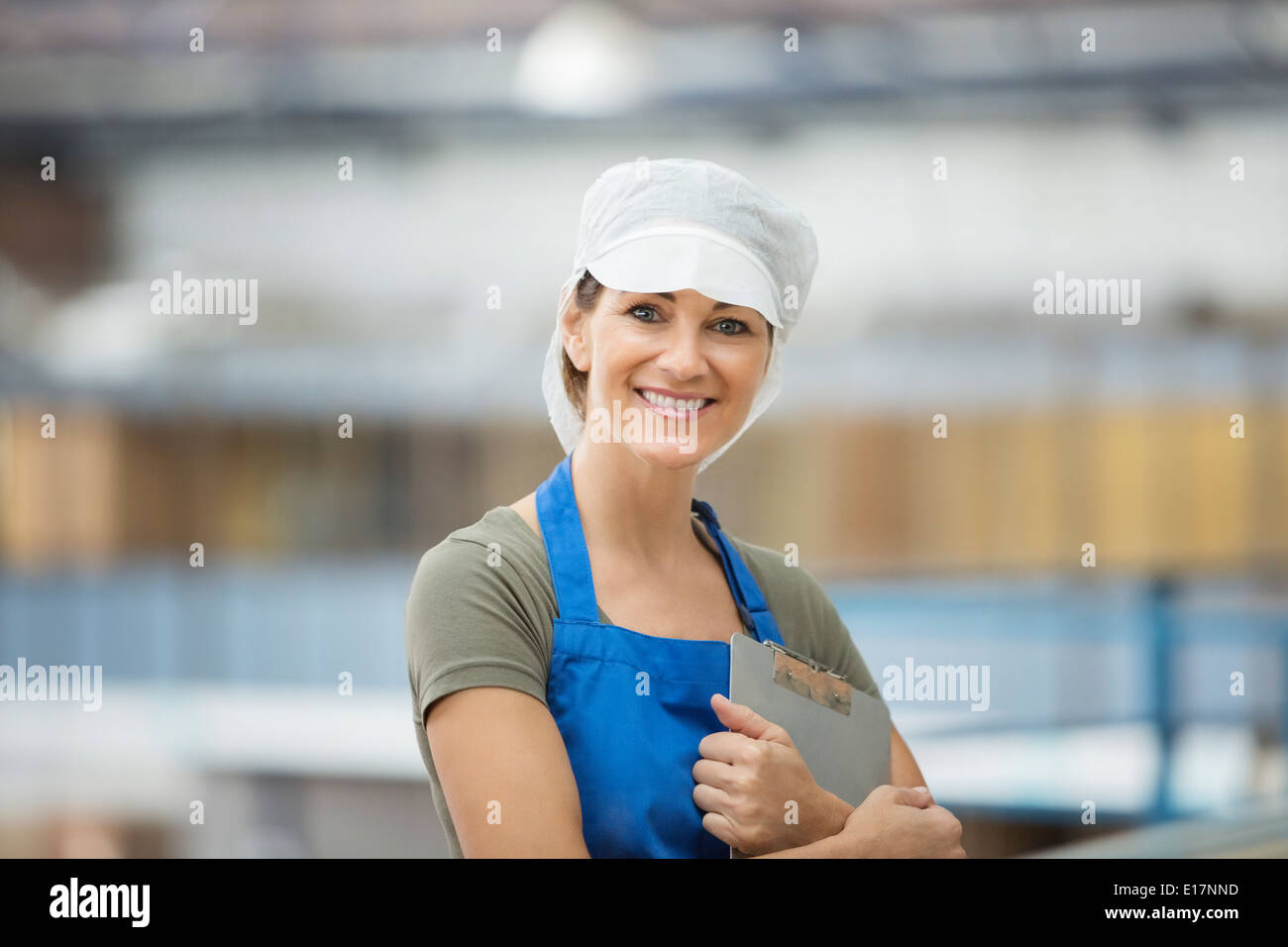 Portrait of confident worker in food processing plant Stock Photo