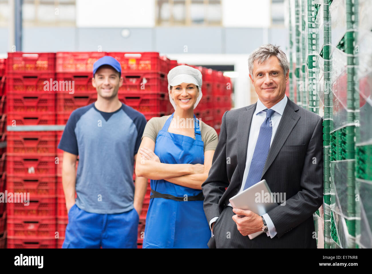 Portrait of supervisor and workers in food processing plant Stock Photo Alamy