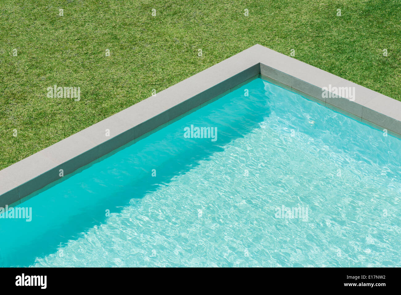 Sunny view of swimming pool in backyard Stock Photo