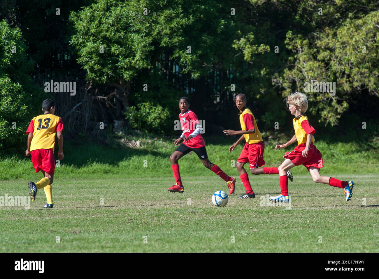 Junior football players chasing the ball, Cape Town, South Africa Stock Photo