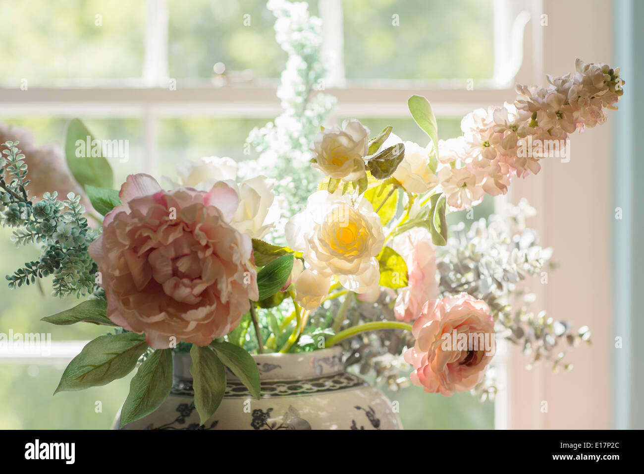 Beautiful bouquet in sunny window Stock Photo