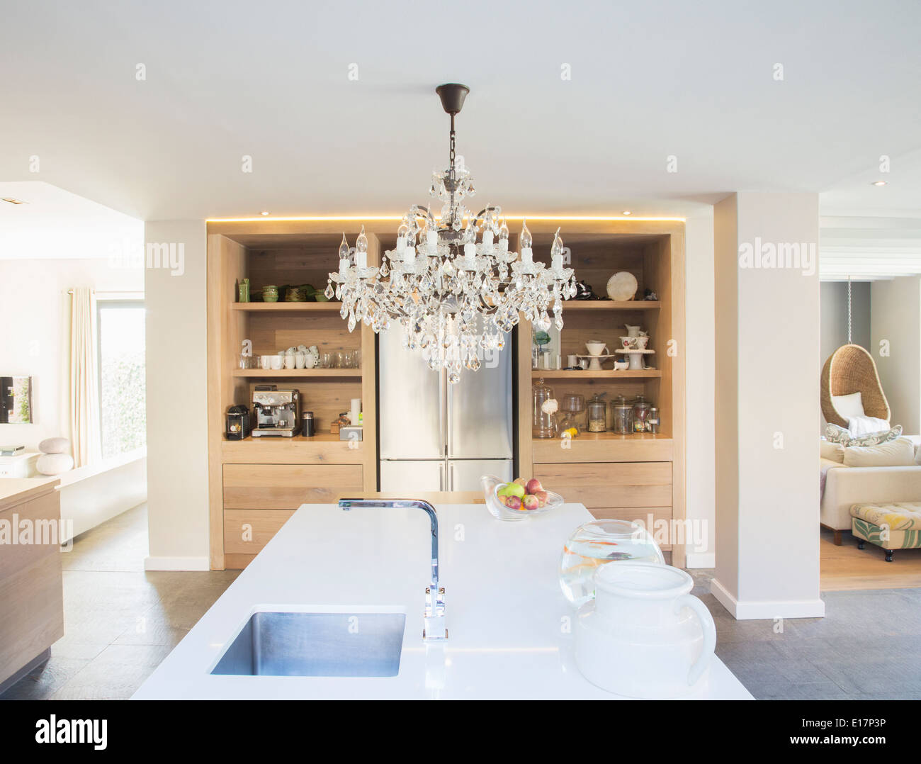 Chandelier hanging over luxury kitchen island Stock Photo