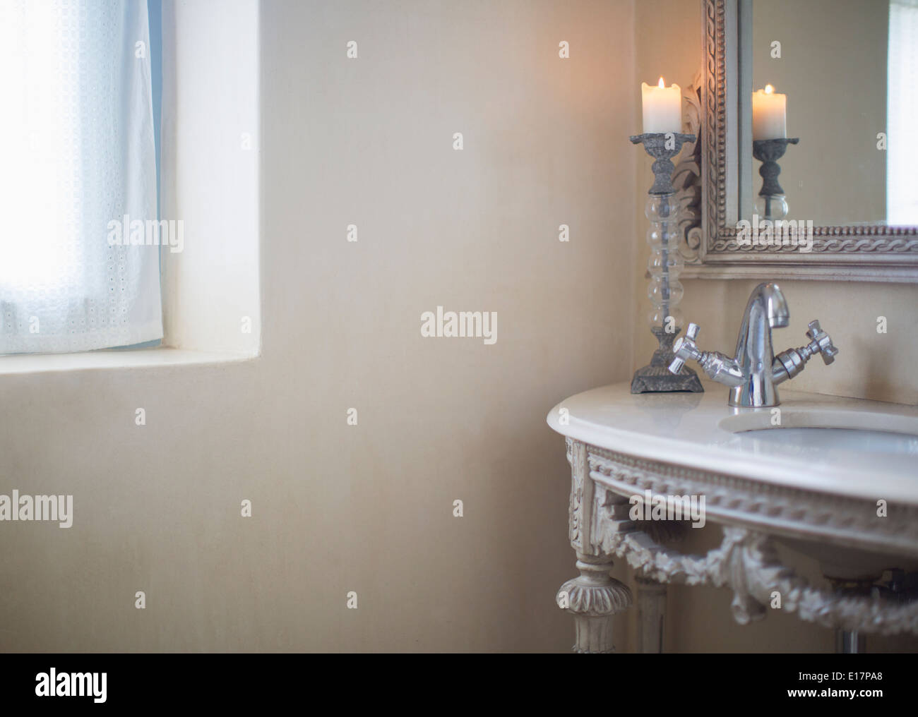 Candle burning in luxury bathroom Stock Photo