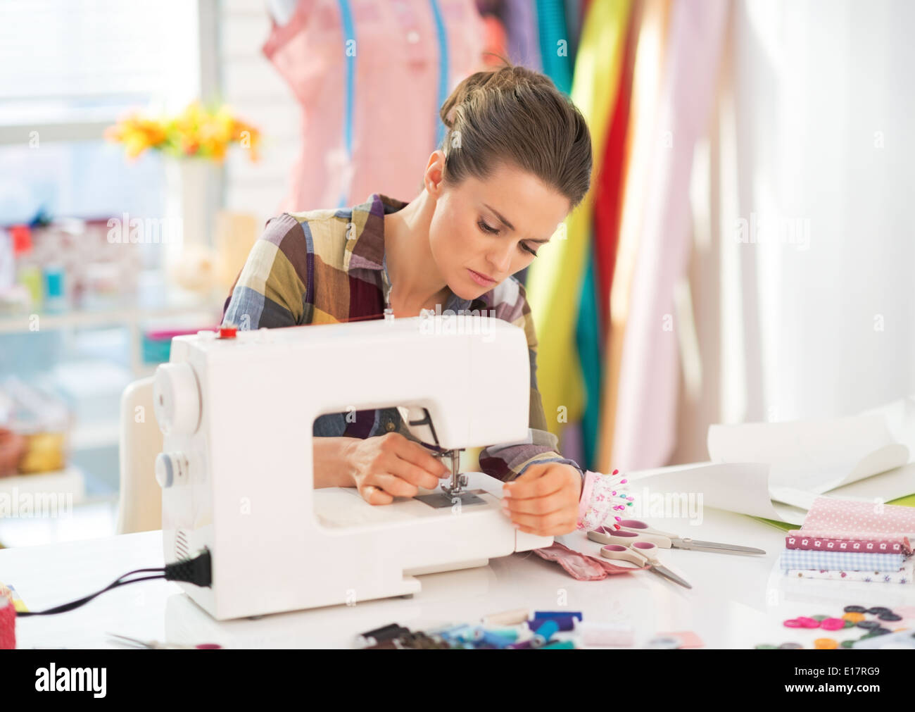 Seamstress working with sewing machine Stock Photo Alamy