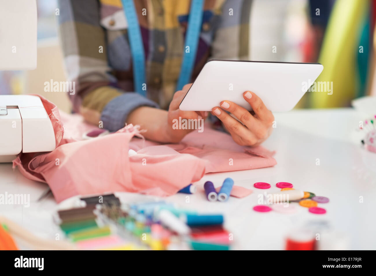 Closeup on seamstress using tablet pc at work Stock Photo