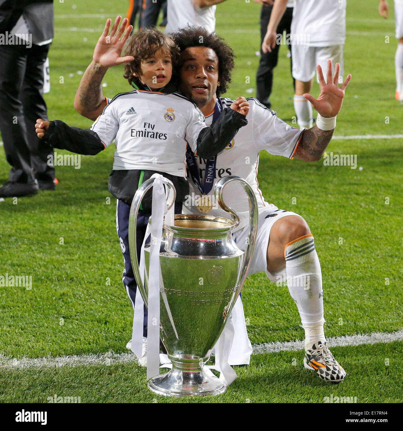 Marcelo (Real Madrid CF #12) showing the ten with his son and the trophy  after the final of the Champions league between Real Madrid and Atletico  Madrid, Estadio da Luz in Lisbon