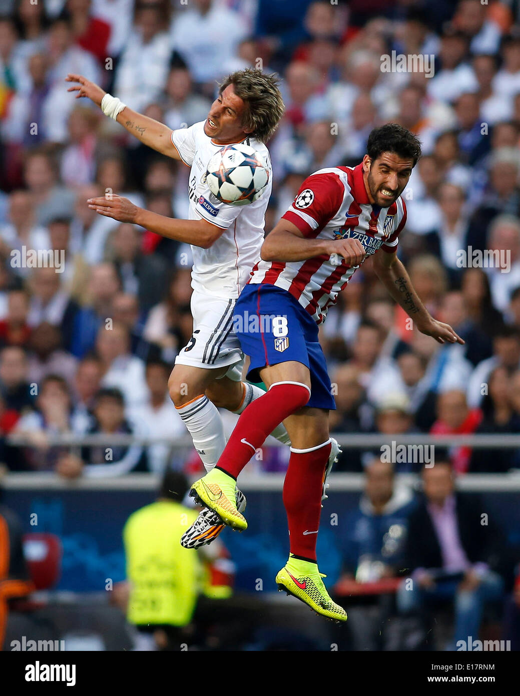 Fabio Coentrao (Real Madrid CF #5) going for a header against Raul Garcia (Atletico Madrid #8) during the final of the Champions league between Real Madrid and Atletico Madrid, Estadio da Luz in Lisbon on May 24., 2014. Stock Photo