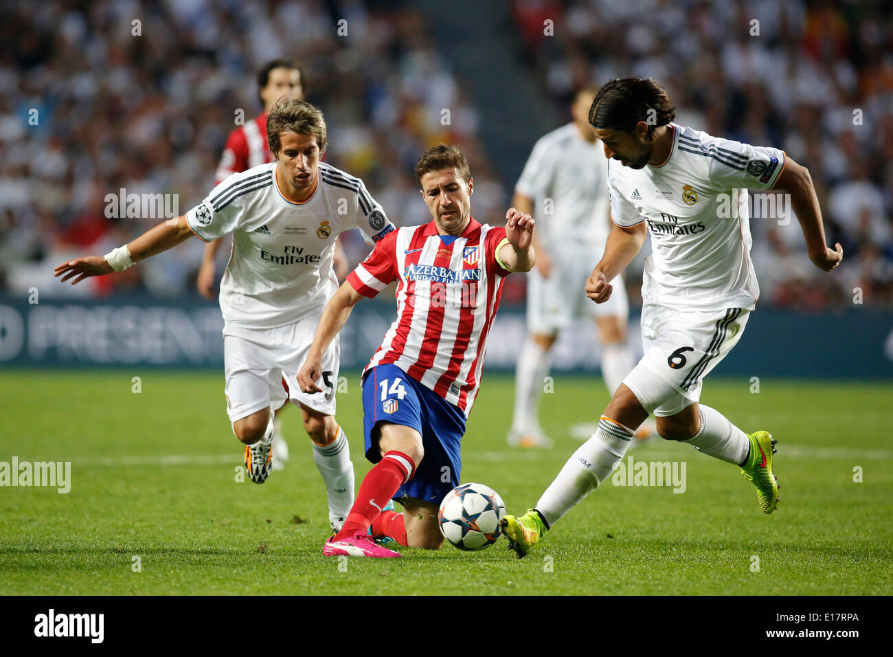 Fabio Coentrao (Real Madrid CF #5) and Sami Khedira (Real Madrid CF #6) tackling against Gabi (Atletico Madrid #14) during the final of the Champions league between Real Madrid and Atletico Madrid, Estadio da Luz in Lisbon on May 24., 2014. Stock Photo