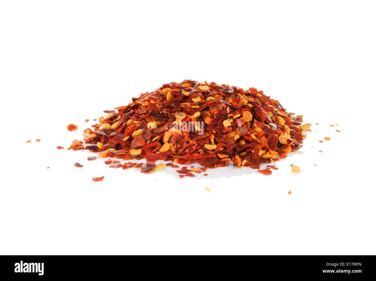 Pile of red pepper flakes on a white background Stock Photo