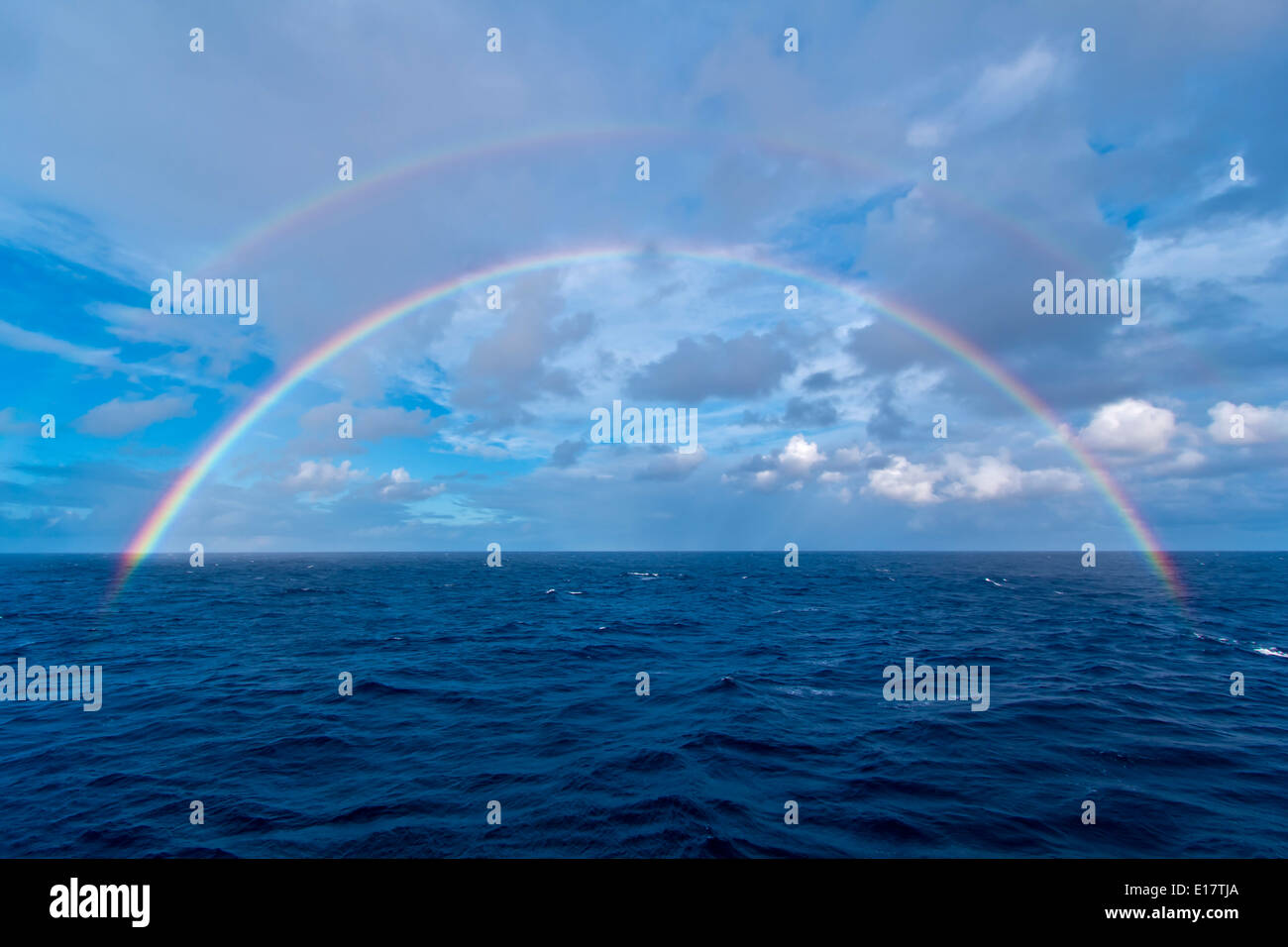 Double rainbow at sea over the Atlantic Ocean, the morning of the total eclipse of the Sun, Nov 3, 2013, from the Star Flyer Stock Photo