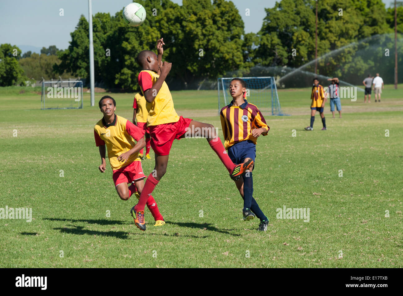 Junior football players heading the ball, Cape Town, South Africa Stock Photo
