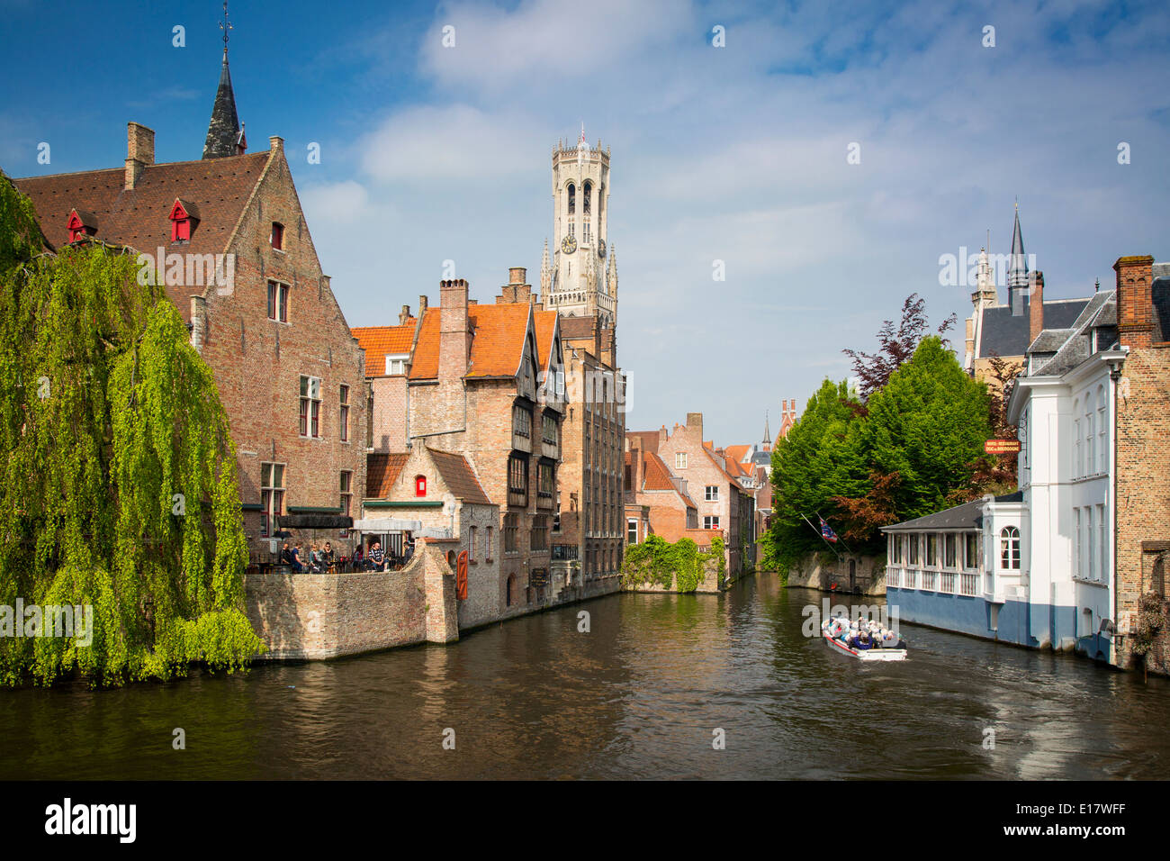 Tourist on boat ride through the canals of Bruges, Belgium Stock Photo
