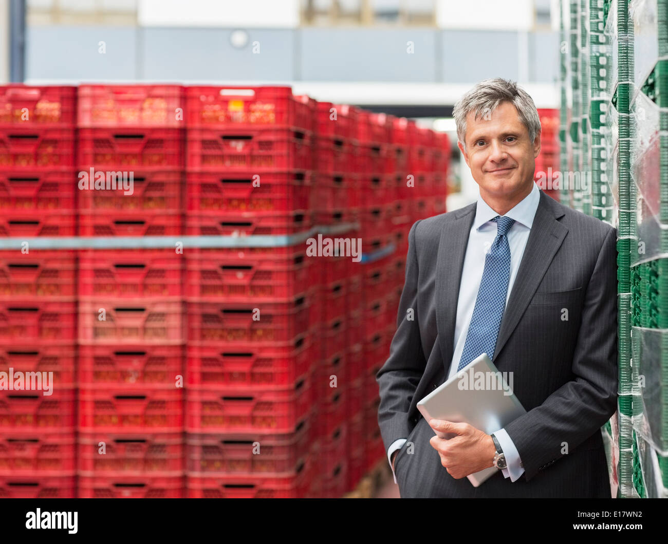 Portrait of confident supervisor with digital tablet in food processing plant Stock Photo