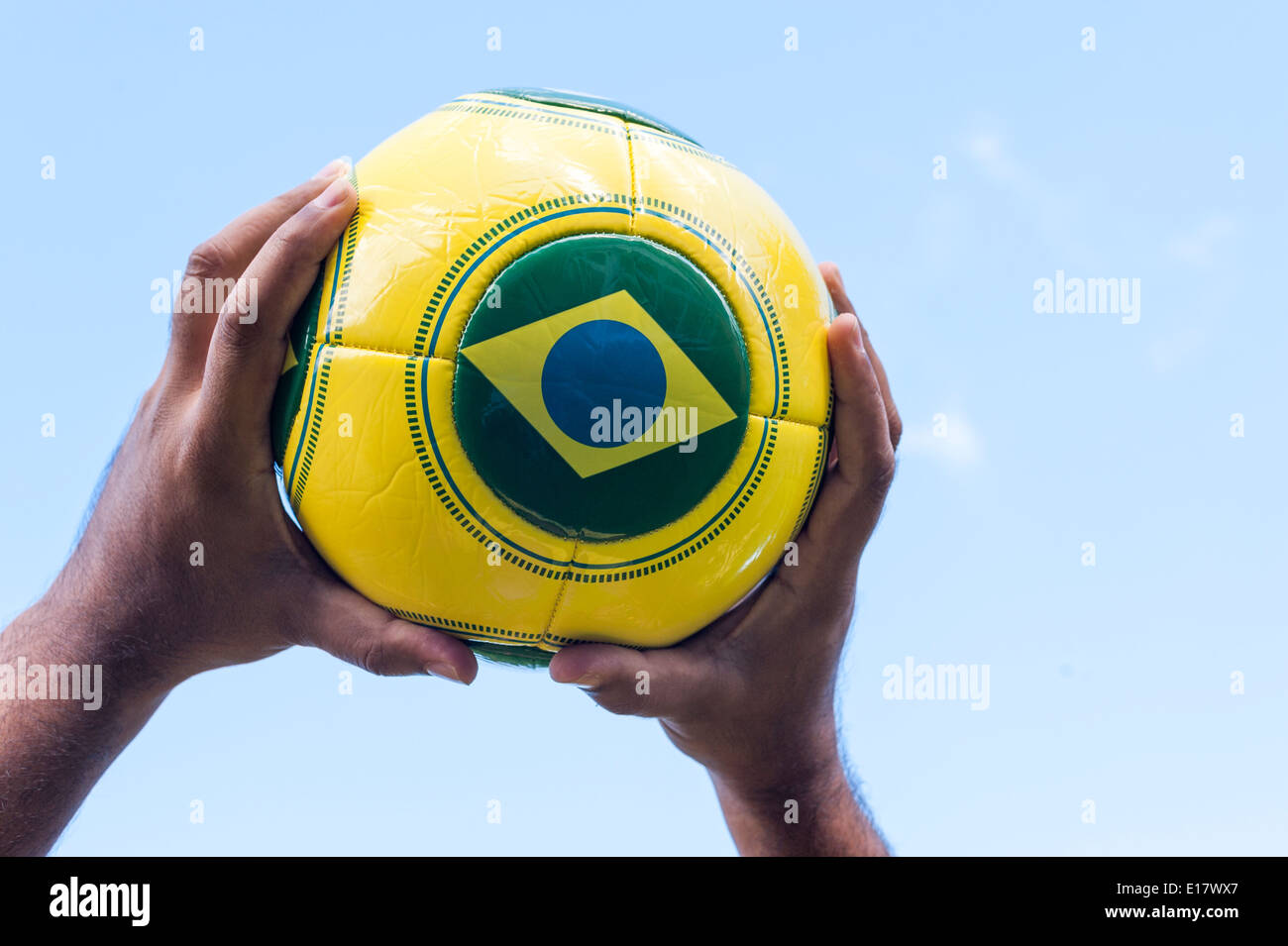 Man with throwing football with Brazil flag for Brazil World Cup 2014. Stock Photo