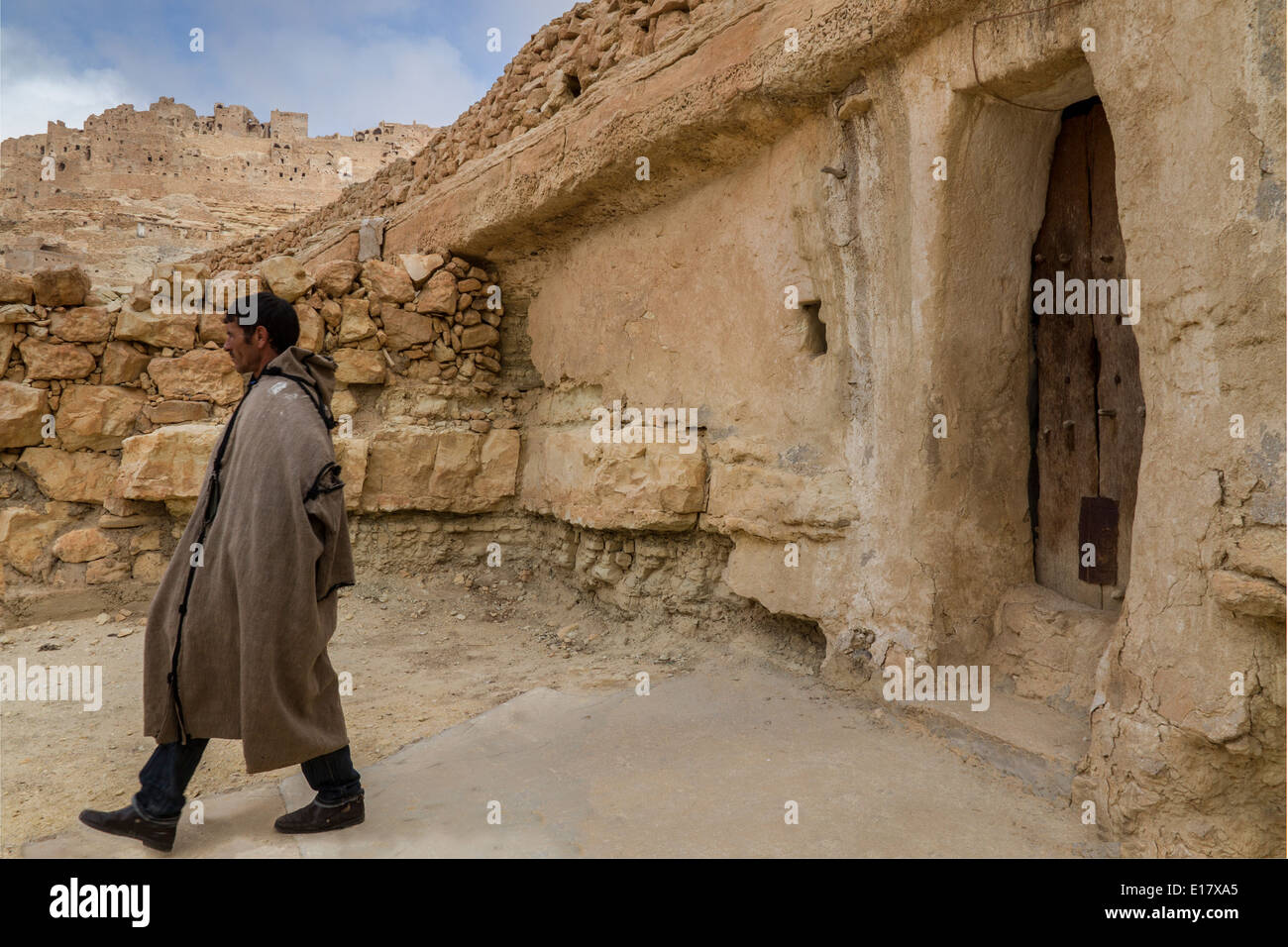 A Berber shepherd leaves his cave house Mountainside Berber Village of Chenini, troglodyte dwellings Stock Photo