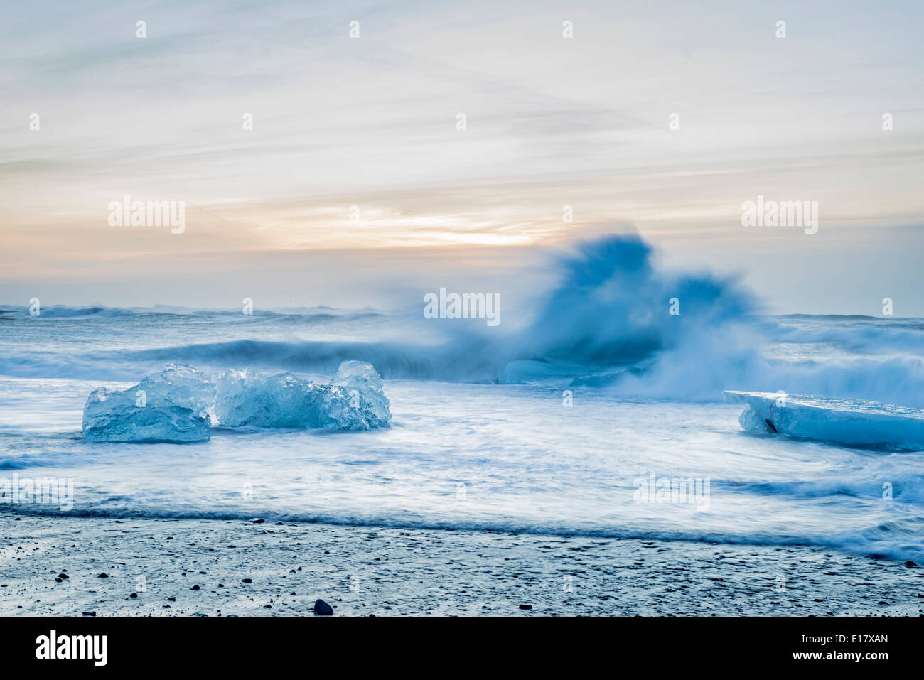 Icebergs and waves crashing on the shoreline at Breidamerkurfjara beach close to Vatnajokull Ice Cap, Iceland Stock Photo