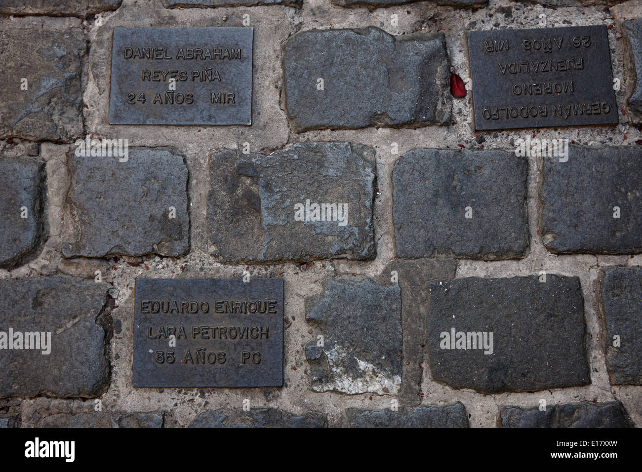 tiles in the footpath to those killed or disappeared outside former prison and torture house in calle londres barrio paris londr Stock Photo