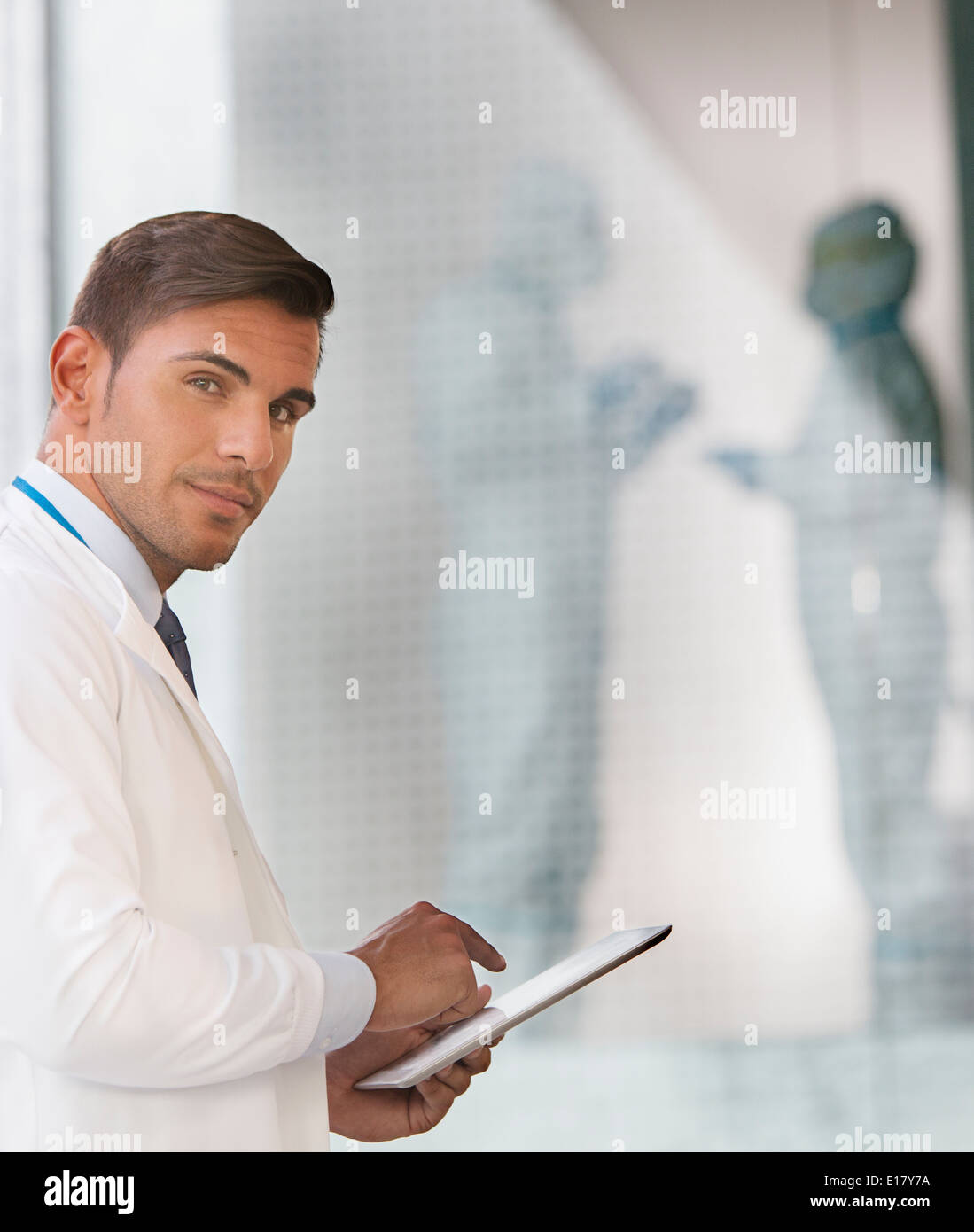 Portrait of confident doctor using digital tablet Stock Photo