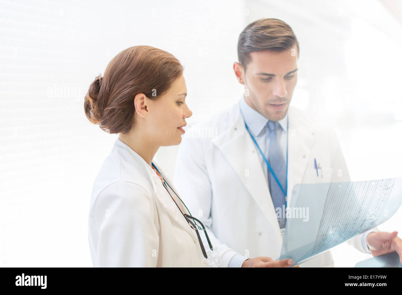 Two doctors examining young woman hi-res stock photography and images ...