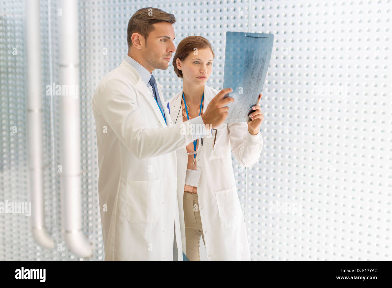 Doctors examining paperwork in hospital Stock Photo