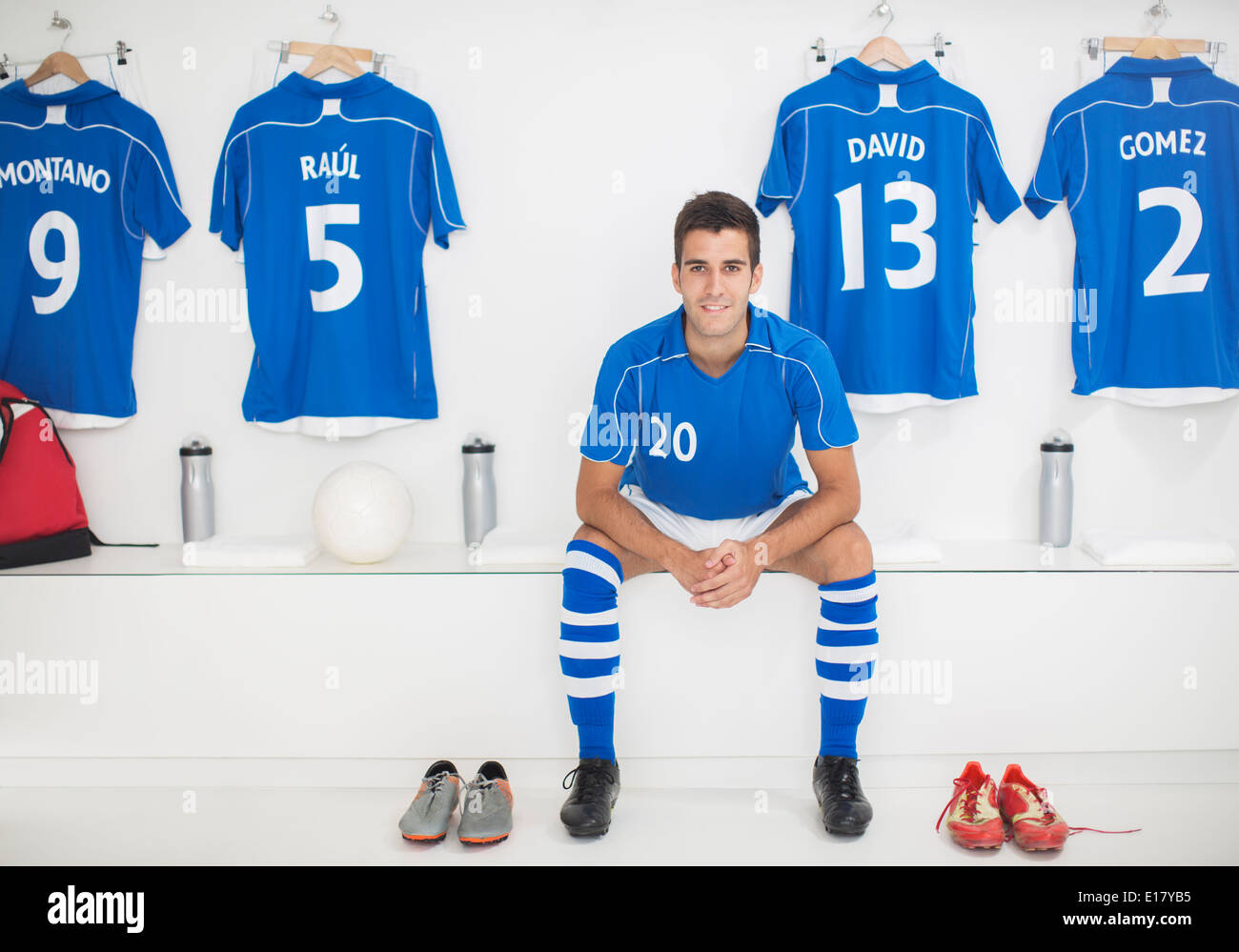 Soccer player sitting in locker room Stock Photo
