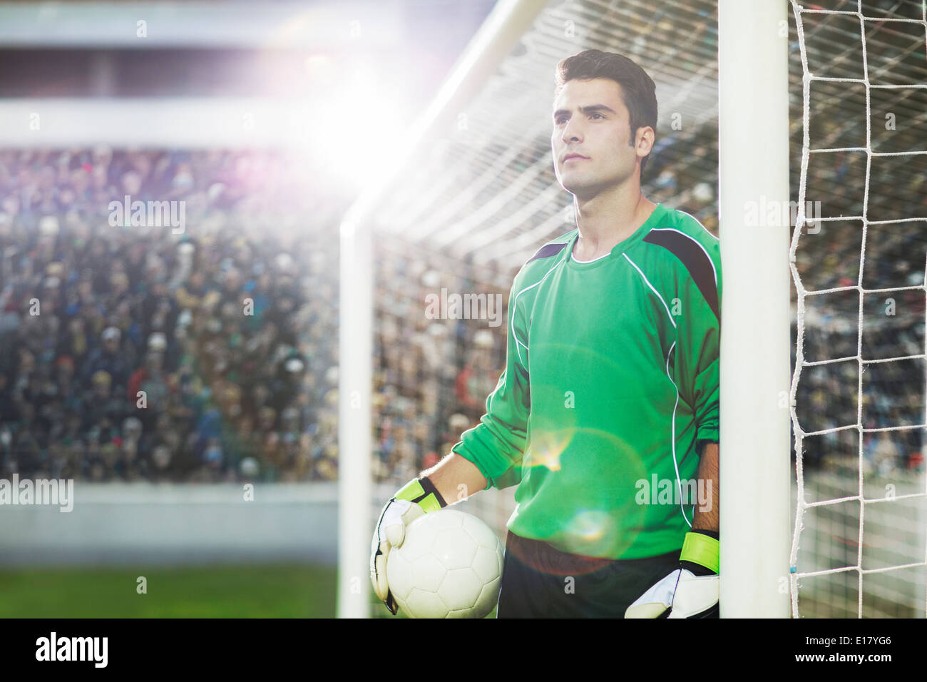 Goalie holding ball on soccer field Stock Photo Alamy