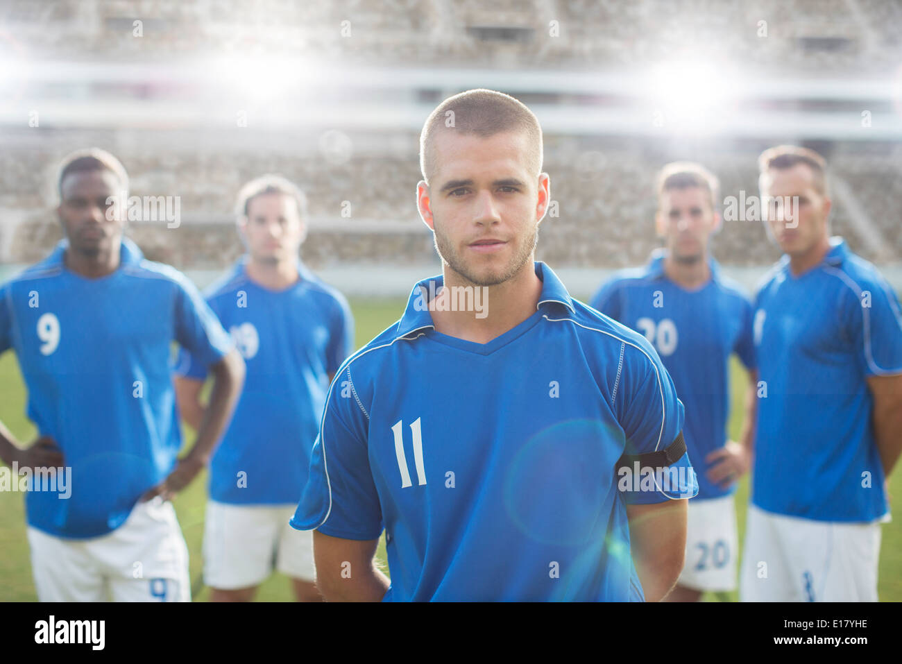 Soccer players standing on field Stock Photo