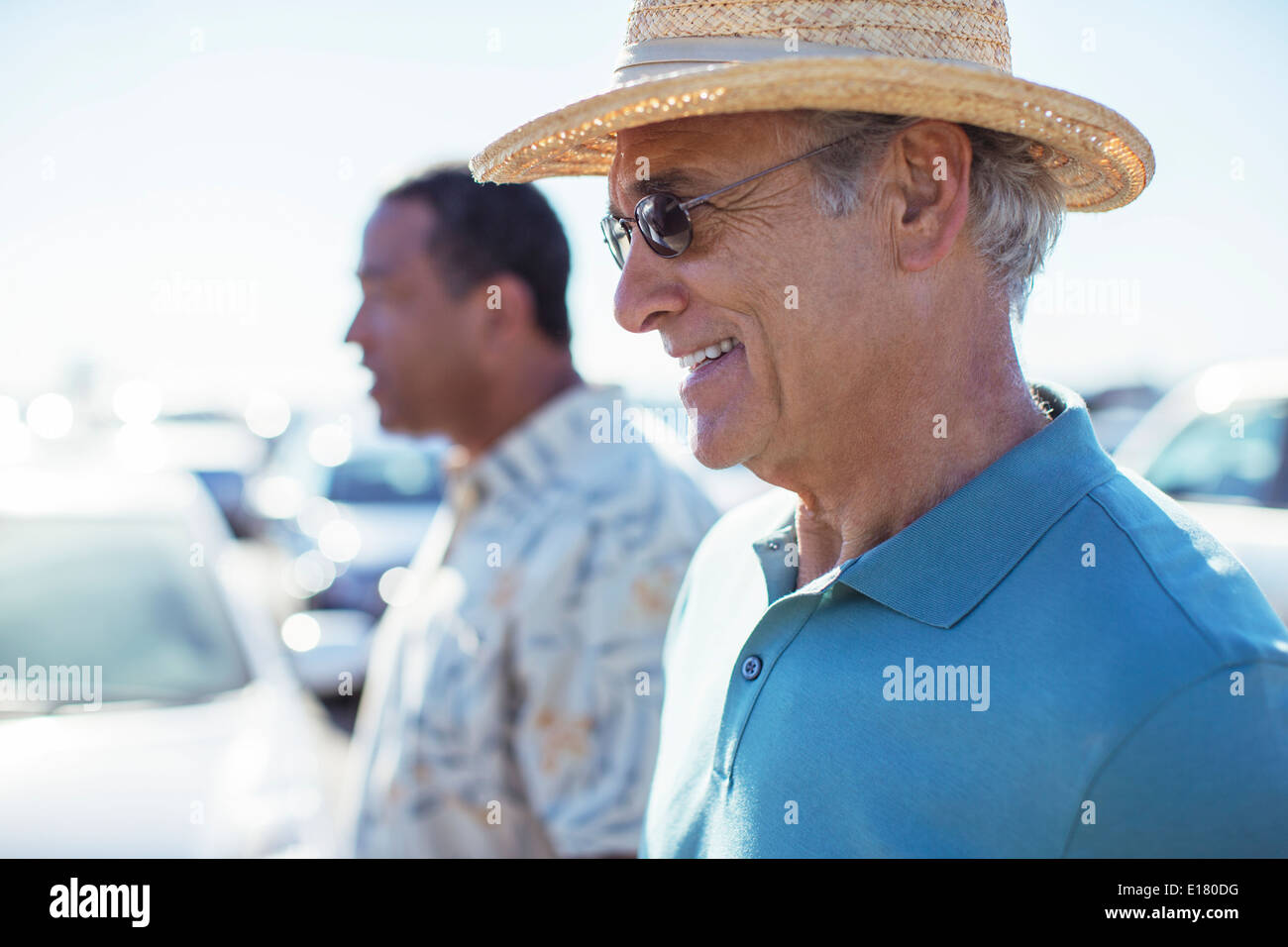 Senior men in sunny parking lot Stock Photo