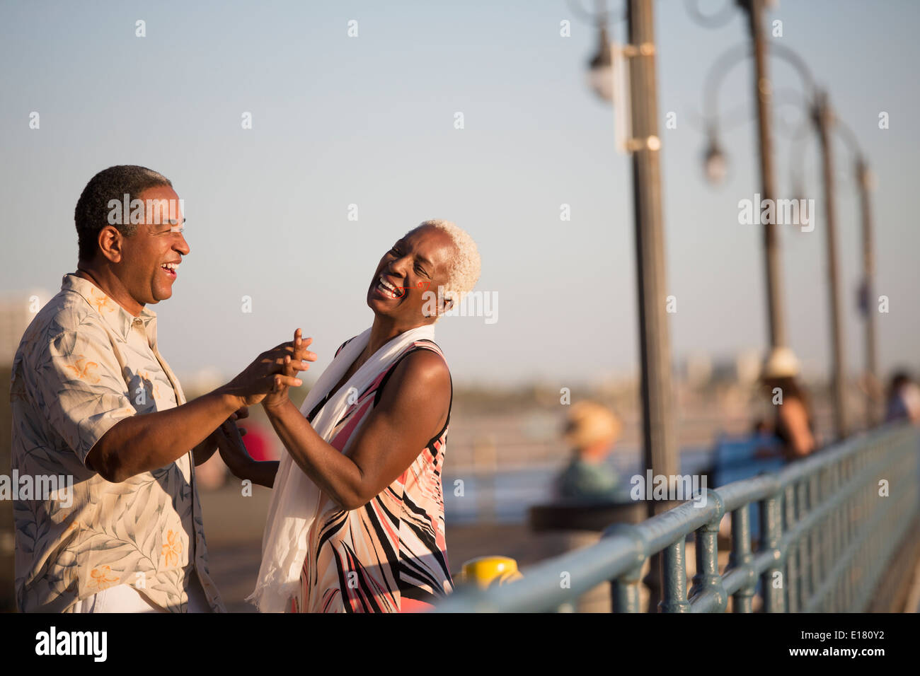 Senior couple dancing on pier Stock Photo