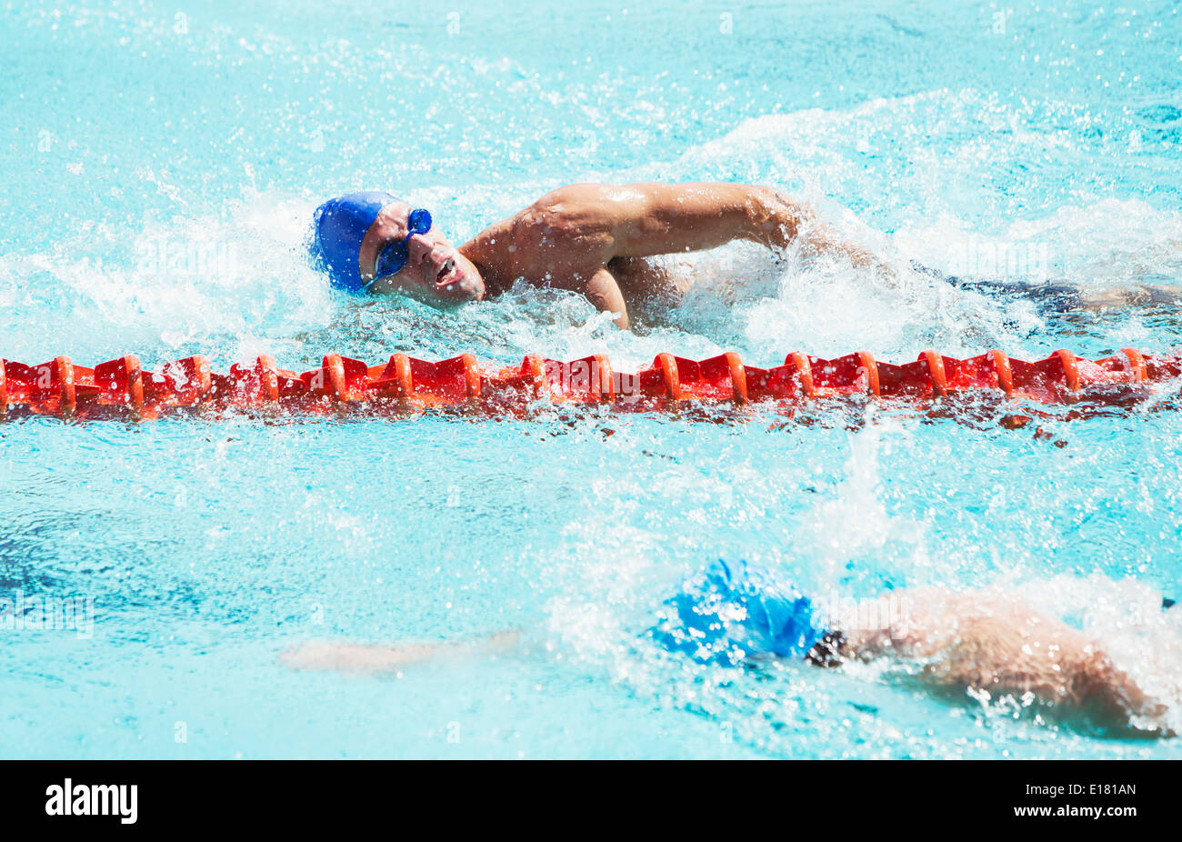 Swimmers racing in pool Stock Photo - Alamy