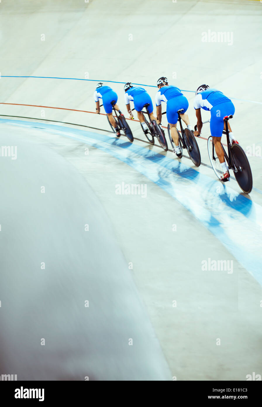 Track cycling team riding in velodrome Stock Photo