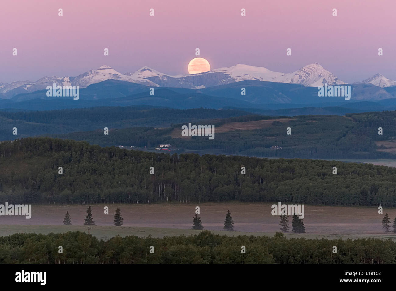Full Moon setting over Rocky Mountains, taken from Rothney Astrophysical Observatory on August 28, 2007, night of total eclipse Stock Photo