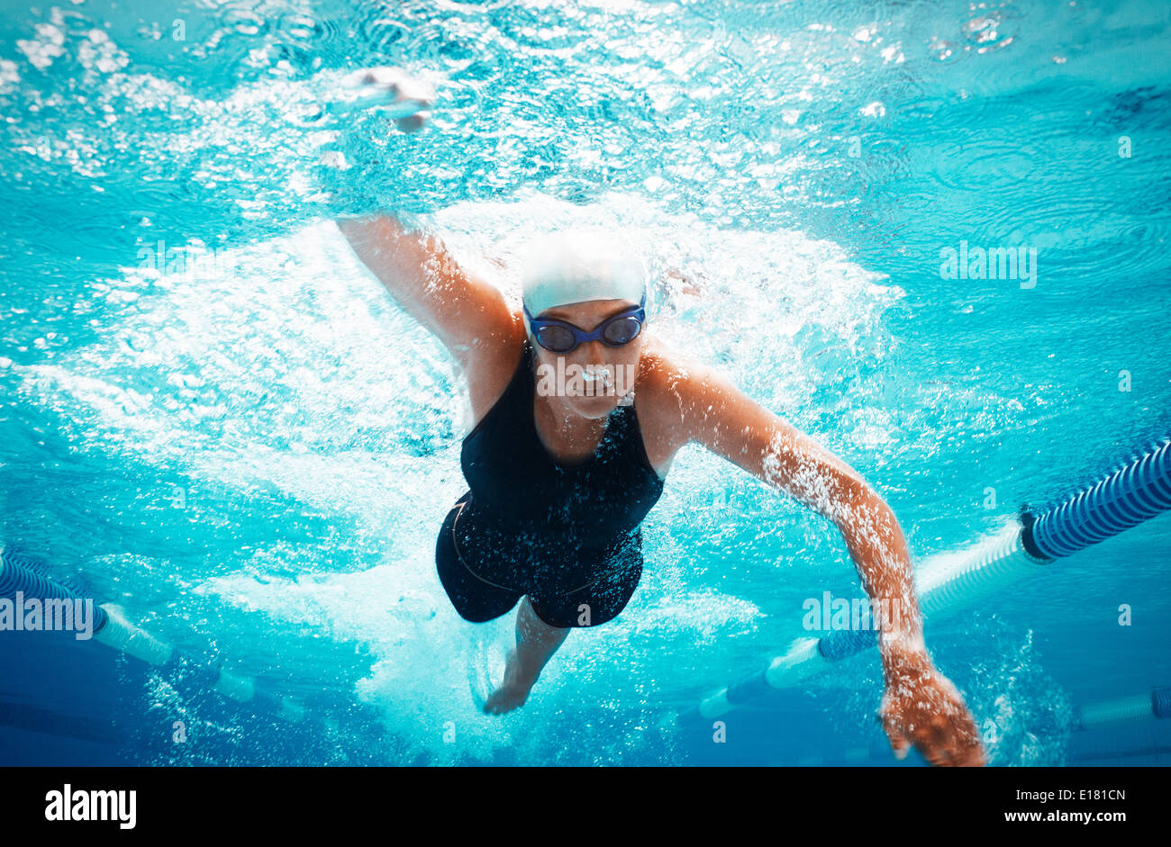 Swimmer racing in pool Stock Photo