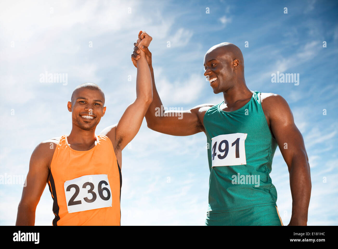 Athletes celebrating together on track Stock Photo