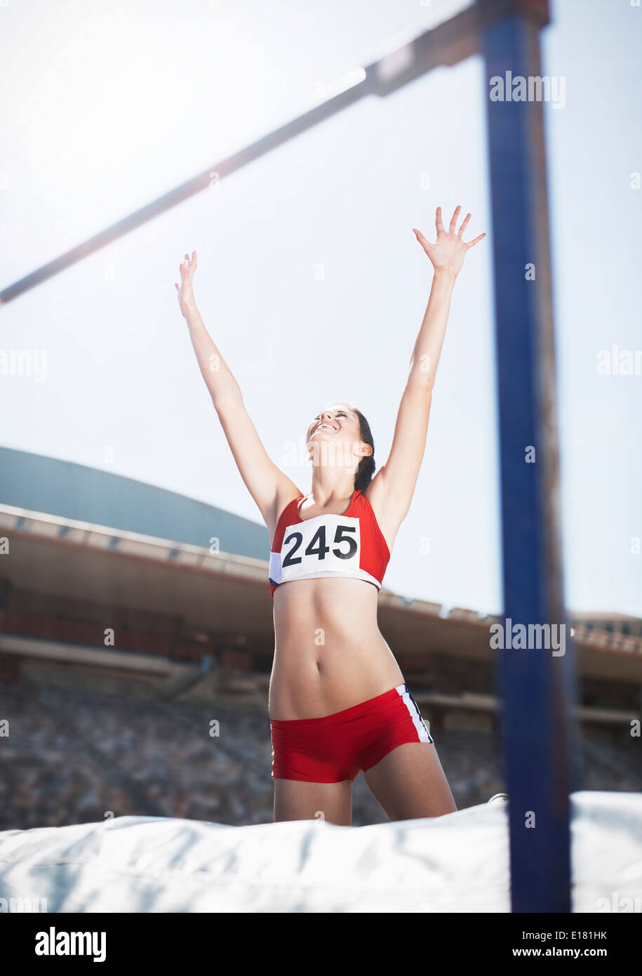 High jumper celebrating on other side of bar Stock Photo