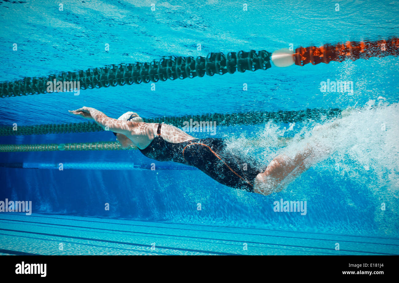Swimmer racing underwater Stock Photo