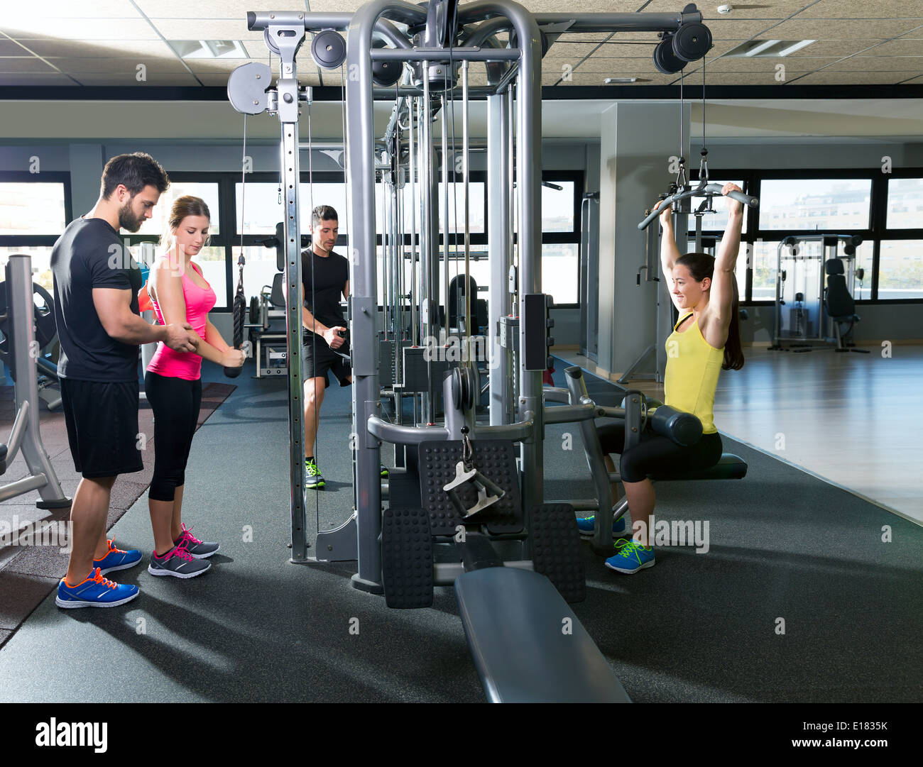 cable pulley system gym workout fitness people with personal trainer Stock Photo Alamy