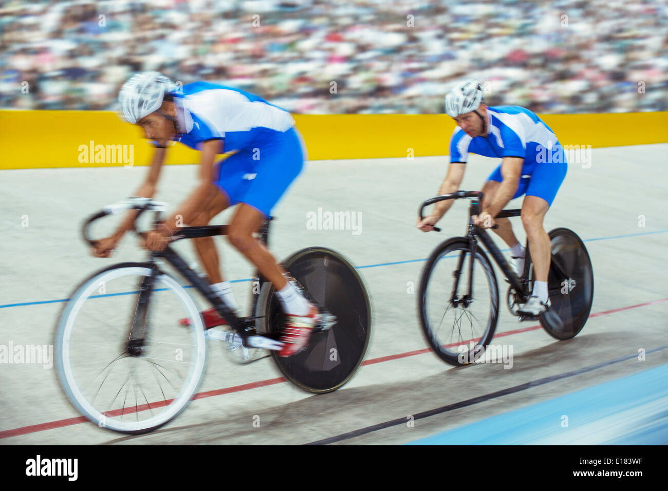 Track cyclists in velodrome Stock Photo