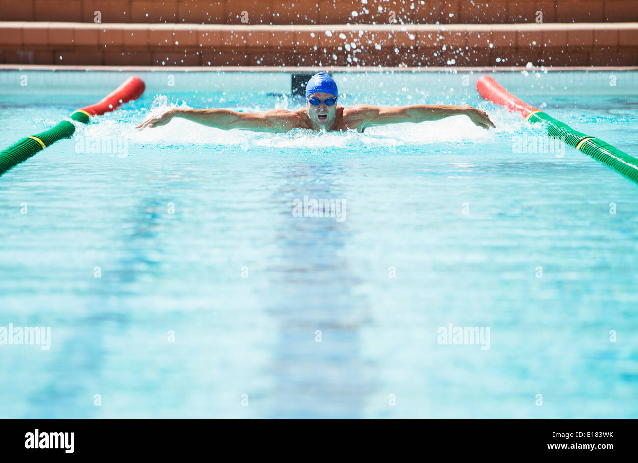 Swimmer racing in pool Stock Photo