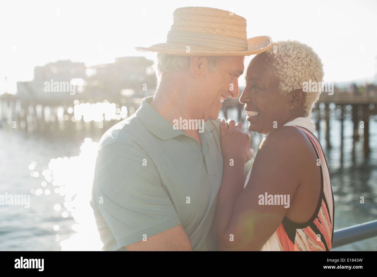 Senior couple hugging on pier Stock Photo