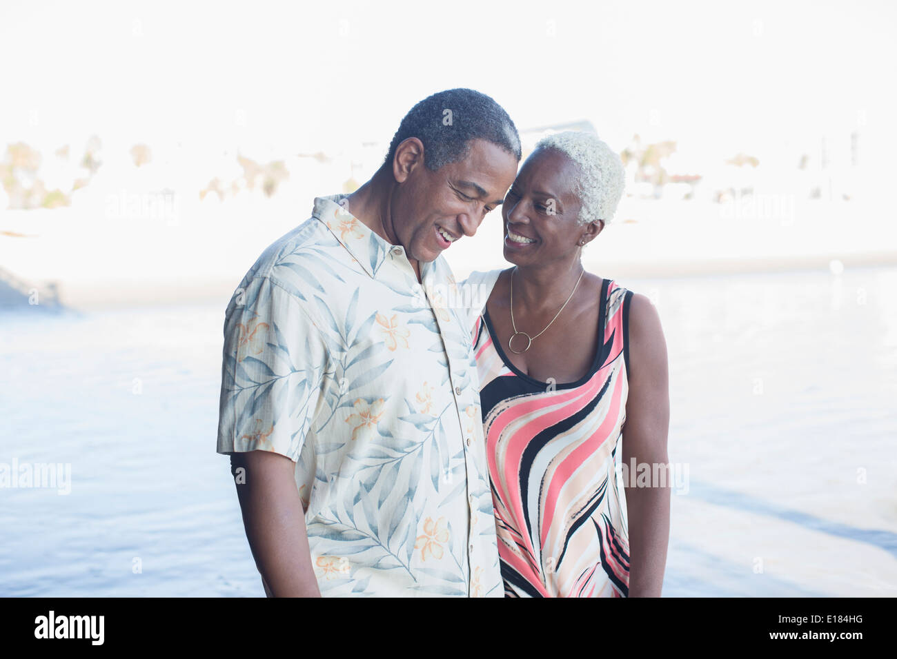 Senior couple walking on beach Stock Photo
