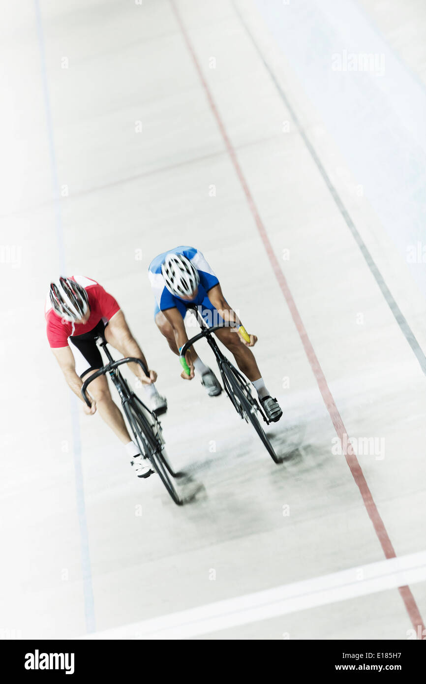 Track cyclists racing in velodrome Stock Photo