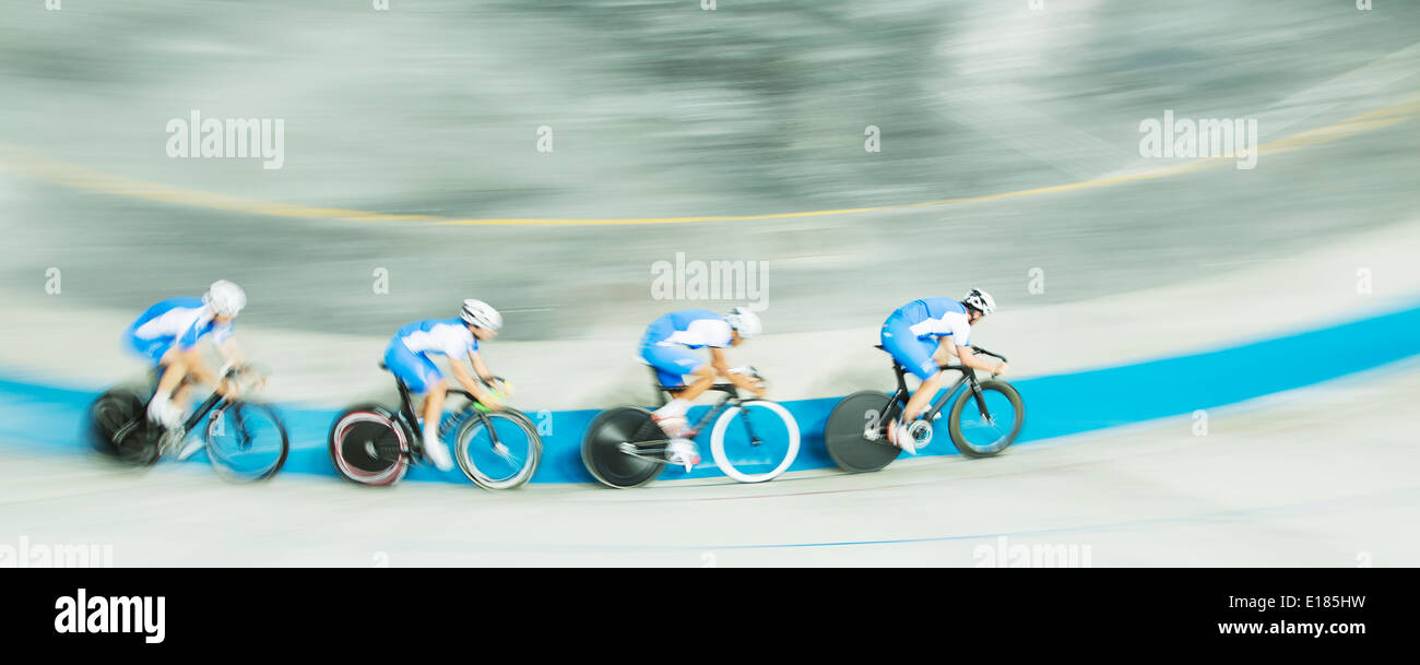 Track cycling team racing in velodrome Stock Photo