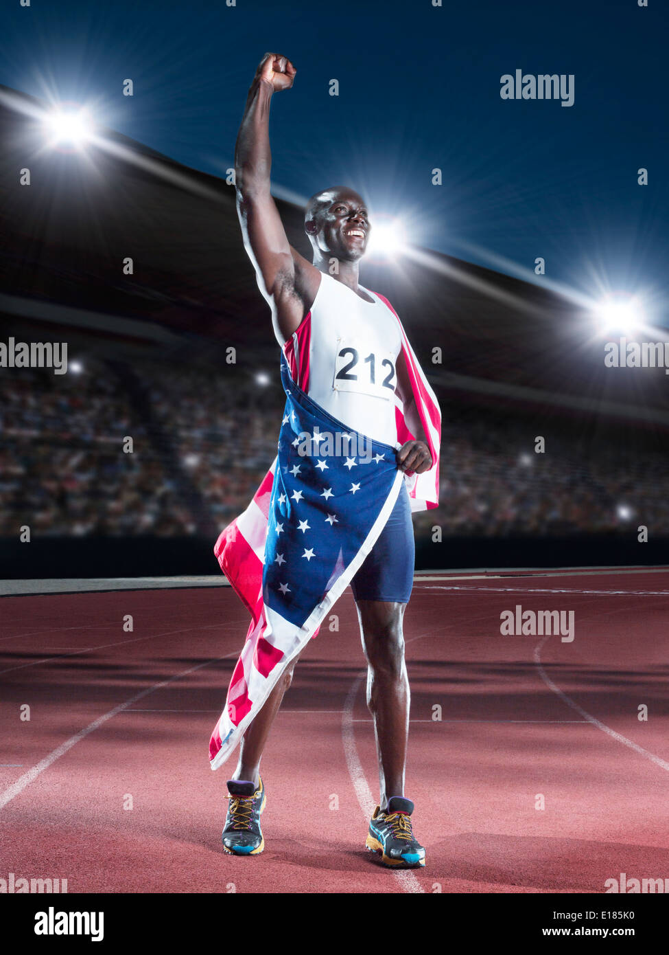 Track and field athlete wrapped in American flag on track Stock Photo