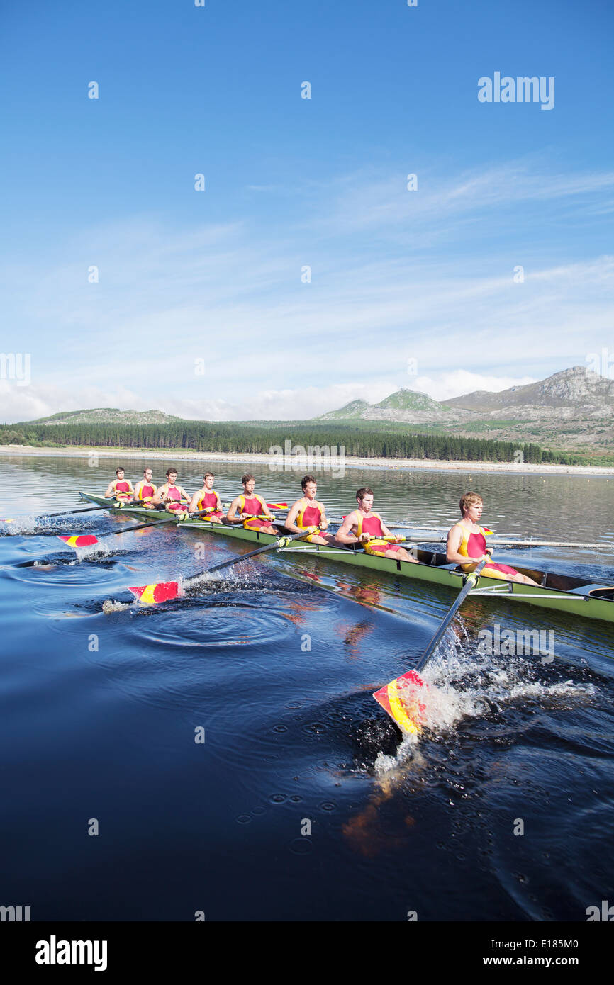 Rowing crew rowing scull on lake Stock Photo