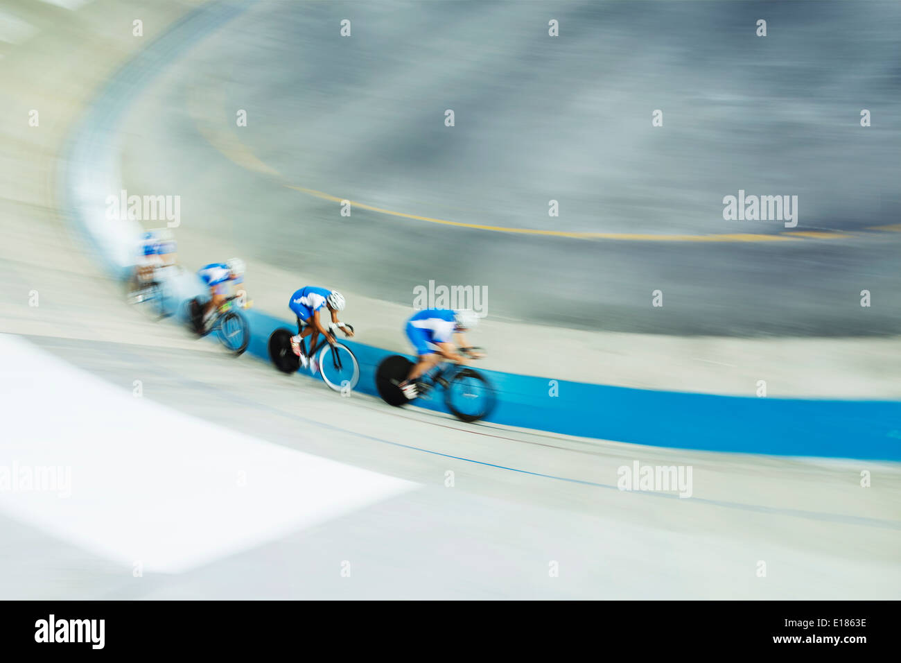 Track cycling team racing in velodrome Stock Photo